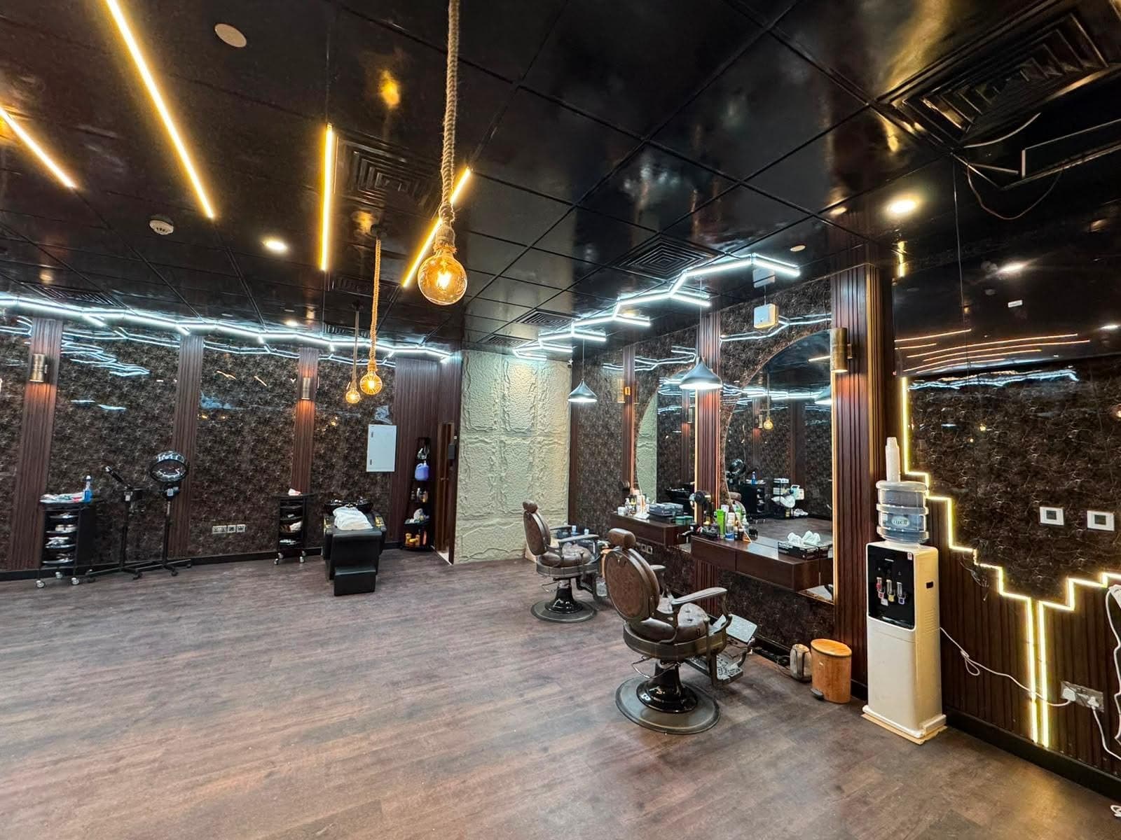 Barber stations with arched mirrors and a hair steamer