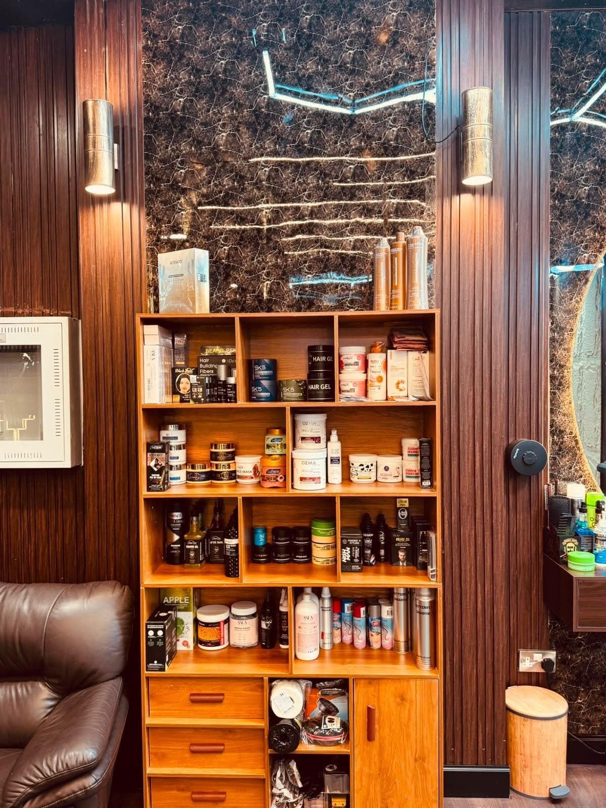 Wooden shelf stocked with hair gels, pomades, beard oils and sprays