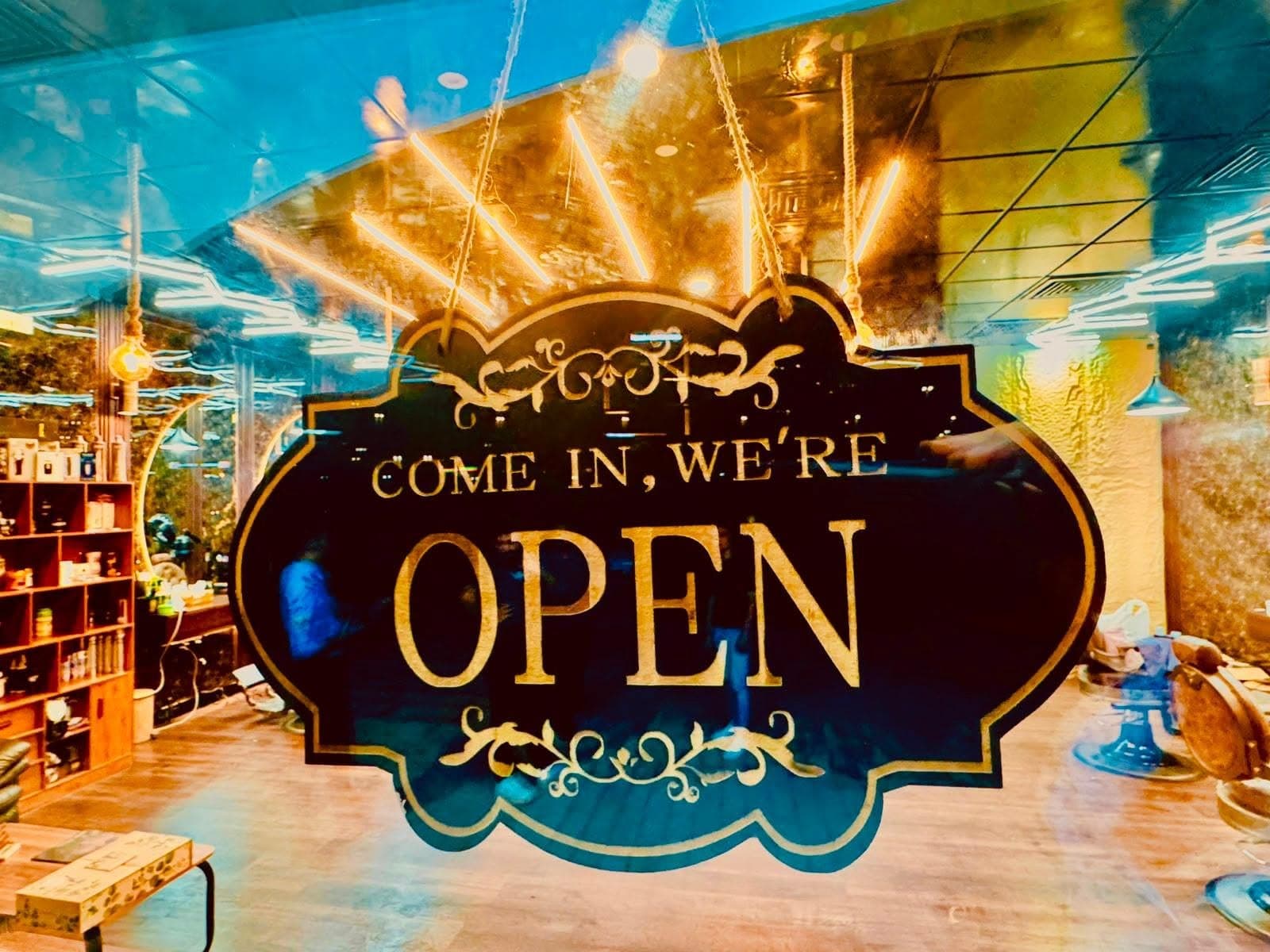 Gold on black 'Come in, we're open' sign